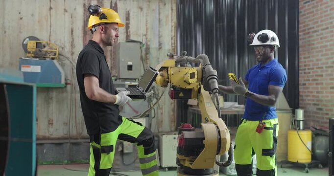 Technicians Troubleshoot Robotic Arm Control System for Automation Maintenance