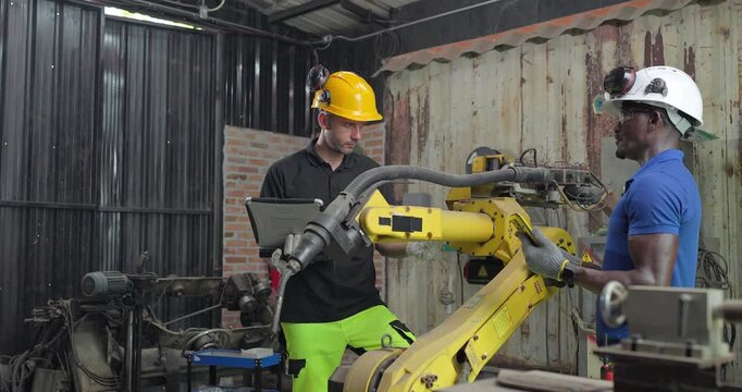 Technicians Troubleshoot Robotic Arm Control System for Automation Maintenance