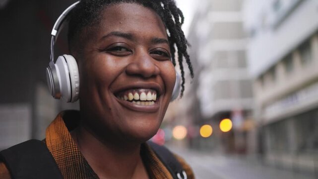 Happy black woman listen music while bus station