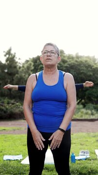 Sport senior people doing yoga exercise at city park - Elderly community and mental health concept