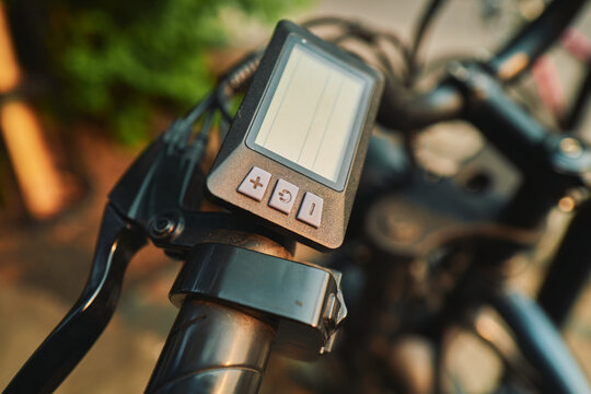 E-bike display screen and buttons in golden light