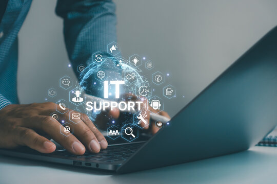 Businessman using laptop with virtual IT support interface, customer service, help desk, technical support, cloud computing, cybersecurity, AI assistance and digital communication technology.