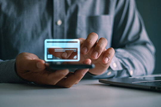 Businessman using smartphone with virtual credit card interface for secure digital payment, online banking, fintech transaction, contactless checkout, mobile finance and e-commerce technology.