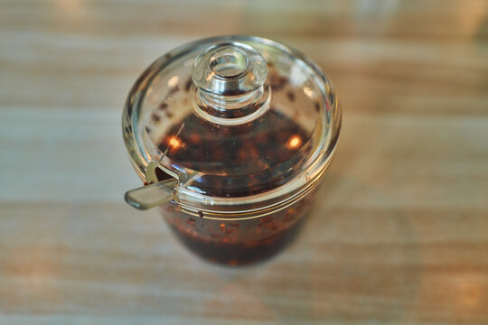 Overhead view of a chili oil jar on a wooden table