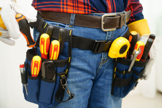 Male builder worker with tool belt pocket at waist.