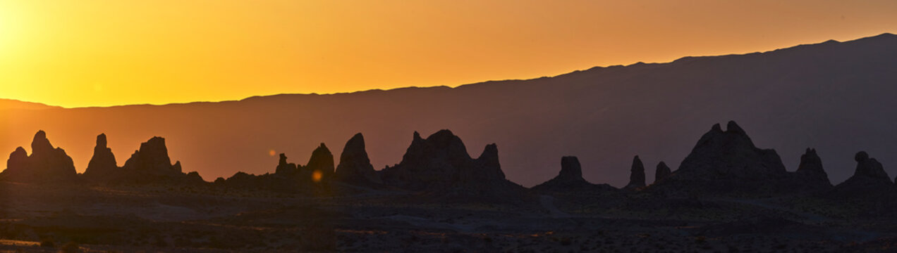 Trona Pinnacles Silhouette at Sunset with Rugged Mountains and Golden Hour Sky