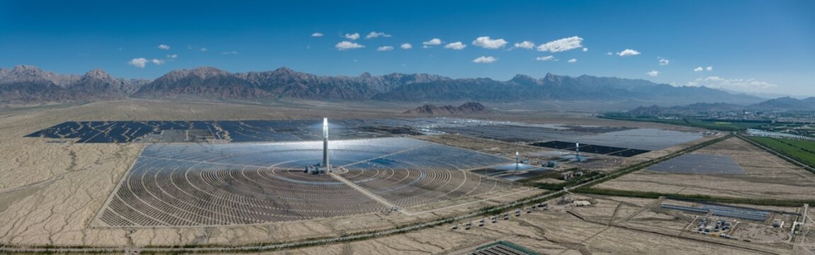 Aerial Panorama of Delingha Molten Salt Solar Thermal Power Plant: Concentrated Solar Power Tower, Heliostat Mirror Array and Mountain Background