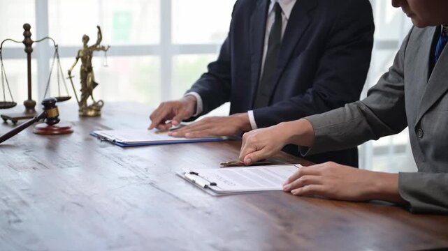 Lawyers shaking hands after signing contract