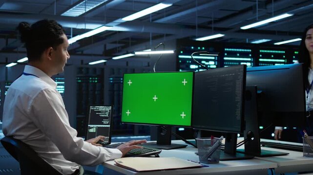 Male engineer monitors cybersecurity risks in a data center, supporting network security, data protection and reliable infrastructure management