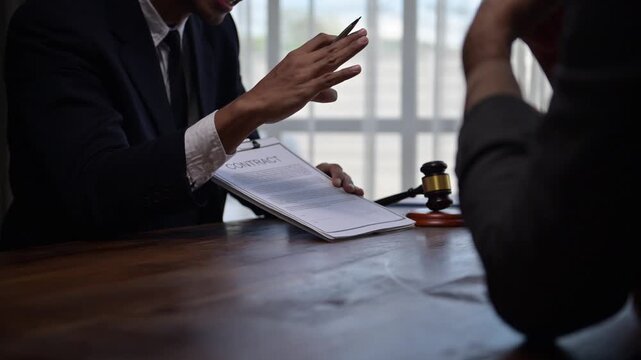 Lawyers discussing contract terms in office meeting