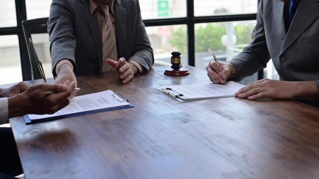 Businessmen signing contract in a meeting room