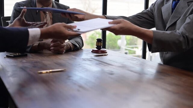 Businessmen shaking hands after signing contract