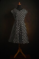 Black and white polka dot short sleeves dress on a mannequin display © Rani