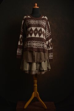 Brown Fair Isle sweater with tiered skirt outfit on display mannequin