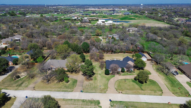 Spacious residential plots showcase substantial distance between custom single family home structures. Aerial perspective outlines low density suburban planning across Double Oak, TX