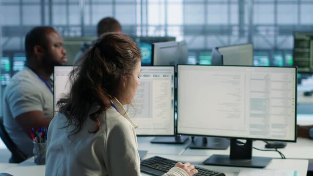 Data center manager overseeing server room holding impromptu meeting with employees while showing secure storage, threat prevention and cybersecurity monitoring.