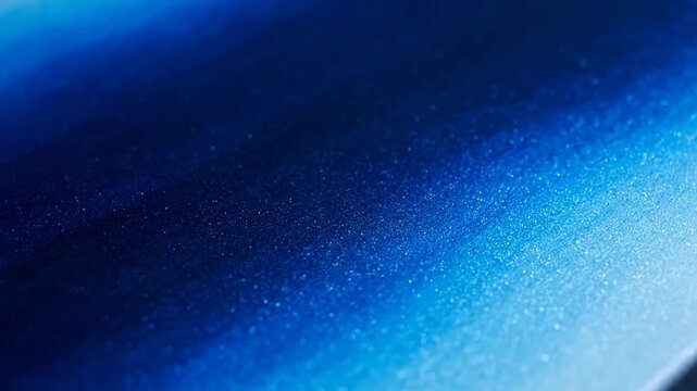 Blue texture features a smooth gradient transitioning from deep navy to bright cyan with fine particles or glitter scattered across the surface to create a modern abstract background for design.