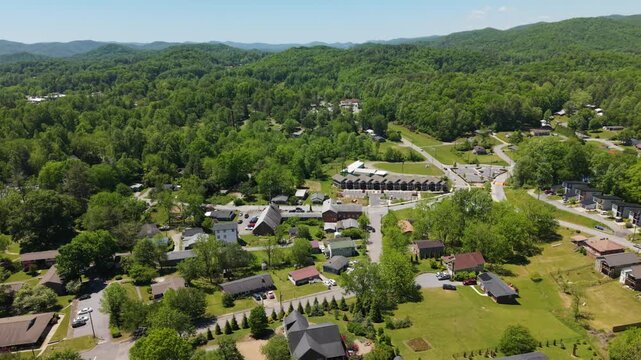 Aerial footage captures the scenic beauty of Brevard, North Carolina, highlighting residential areas, greenery, and winding roads amidst the mountains