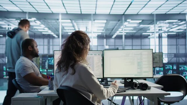 System admin operating in diverse computer network security data center from a secondary camera angle while highlighting configuration review, rackmount performance and network troubleshooting.