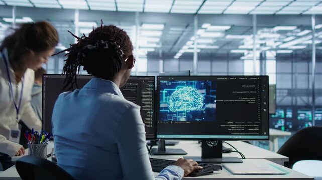 Technician inspects rackmounts in server room using artificial intelligence tech from a secondary camera angle while capturing energy consumption, system reliability and equipment supervision.