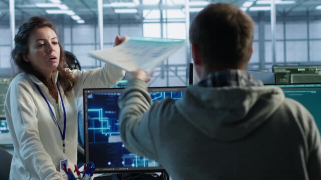 Team leader supervises an engineer making software that produces AI videos, linking diffusion model development with technical guidance in a data center.