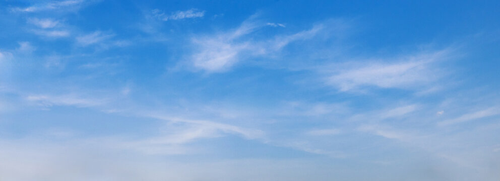 Clear blue sky with wispy clouds above