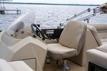 Captain's chair and helm of a modern pontoon boat © Olha Semeniv