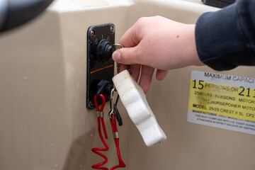 Turning the ignition key on a boat console © Olha Semeniv