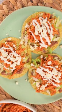 A plate with Mexican chicken tinga tostadas or Mexican toasts