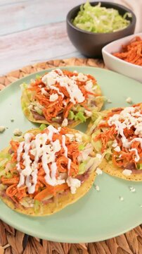 Top view of Mexican tostadas on a green plate