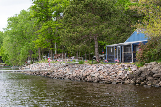 Blue cabin and rocky shoreline on a lake
