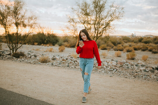 Fall Portrait of Girl in Red Sweater Looking at Phone