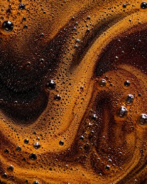Close up surface of freshly brewed black coffee showing dynamic foam pattern