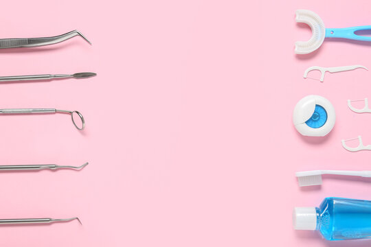 Dental instruments and oral hygiene products arranged on a pink background for dentistry and health care concepts, the left side displays various stainless steel dental tools including a mirror