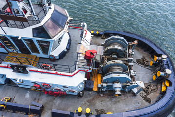 Top-down view of a modern tugboat highlighting its bridge, working deck and marine equipment during navigation through the Panama Canal. © Mariusz