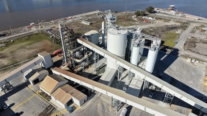 Aerial view processing plant cement silos conveyors © GoAerials