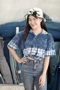 Asian woman in hand-dyed indigo shirt. Authentic Thai natural craft from Sakon Nakhon.
