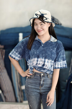 Asian woman in hand-dyed indigo shirt. Authentic Thai natural craft from Sakon Nakhon.