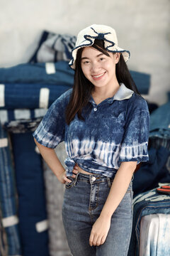 Asian woman in hand-dyed indigo shirt. Authentic Thai natural craft from Sakon Nakhon.