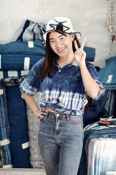 Asian woman in hand-dyed indigo shirt. Authentic Thai natural craft from Sakon Nakhon.