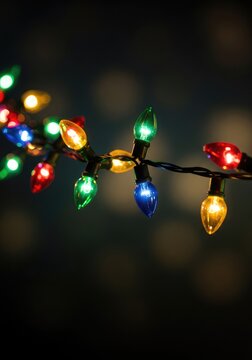 Vibrant holiday string lights twinkle and glow in a magical festive animation featuring multicolored bulbs on a dark, soft background, colorful, abstract, sparkles