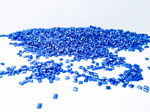 Blue masterbatch granules , cold cutting type, polymer carries color pigment poured into a white background medium, suitable for product catalog design of industrial plastic company profiles