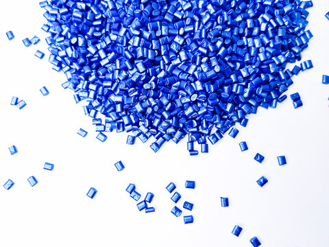 Blue masterbatch granules, cold cutting type, polymer carries color pigment poured into a white background medium, suitable for product catalog design of industrial plastic company profiles