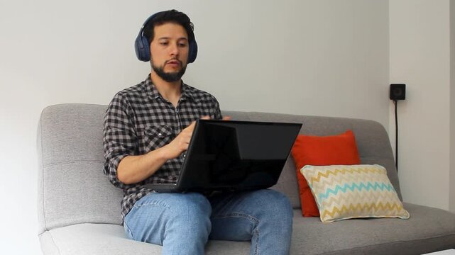 Detailed view of a latin man explaining something in a video meeting in a remotely work concept