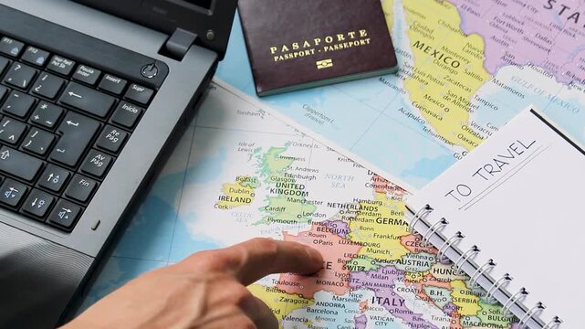 Detailed view of a male hand pointing with his index finger to france country into a travel concept