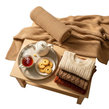 Stack of sweaters and plate of food.