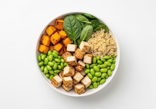 Vibrant vegetarian bowl featuring roasted pumpkin, fluffy quinoa, fresh baby spinach, green edamame beans, and cubes of seared organic tofu, tofu, pumpkin, cooking