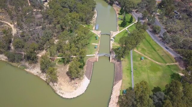 Aerial view of Mildura Weir and Lock 11 on the Murray River in Victoria, Australia, showcasing the historic lock system, weir structure, and river waters - DLOG Flat File 4K