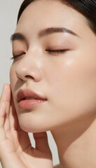 Obraz premium Luxury Beauty Portrait of Young Woman with Glowing Skin and Closed Eyes in Warm Sunlight