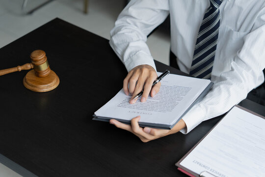 Lawyer reading legal document in office room